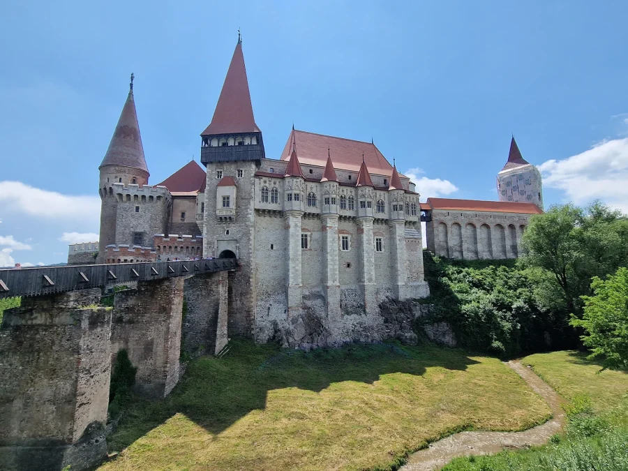 Corvin Castle above Hunedoara, its red-roofed towers and timber bridge rising from the rock