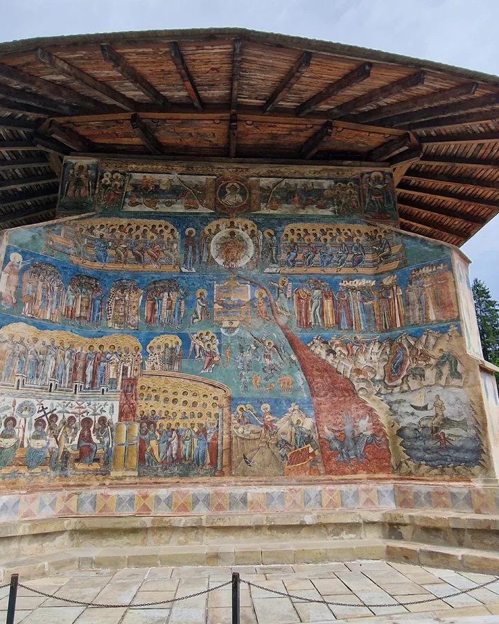 The Last Judgement fresco across the west wall of Voroneț Monastery, under its wide eaves