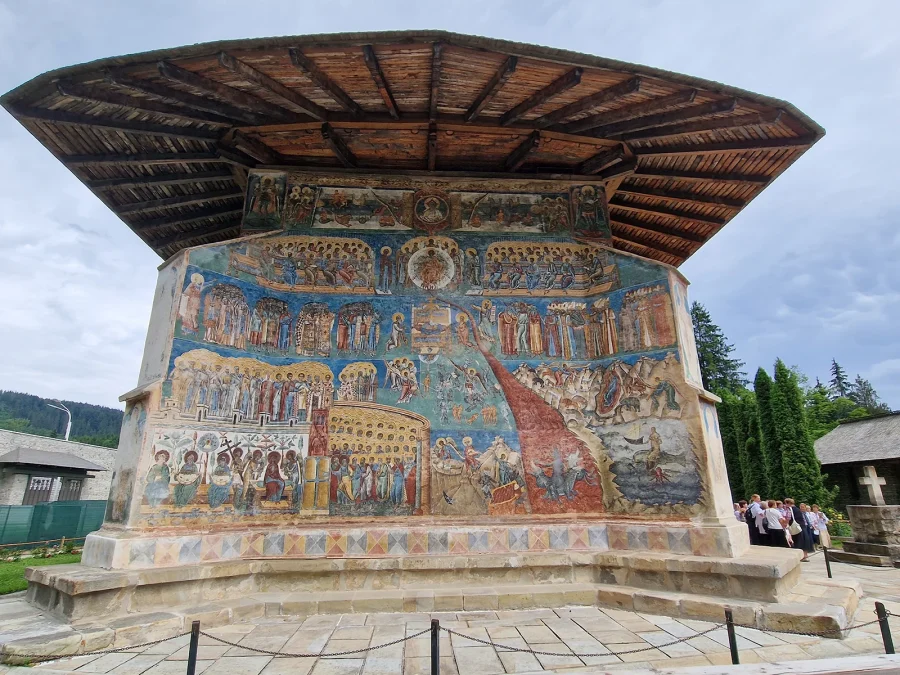 The Last Judgement fresco across the west wall of Voroneț Monastery, under its wide eaves